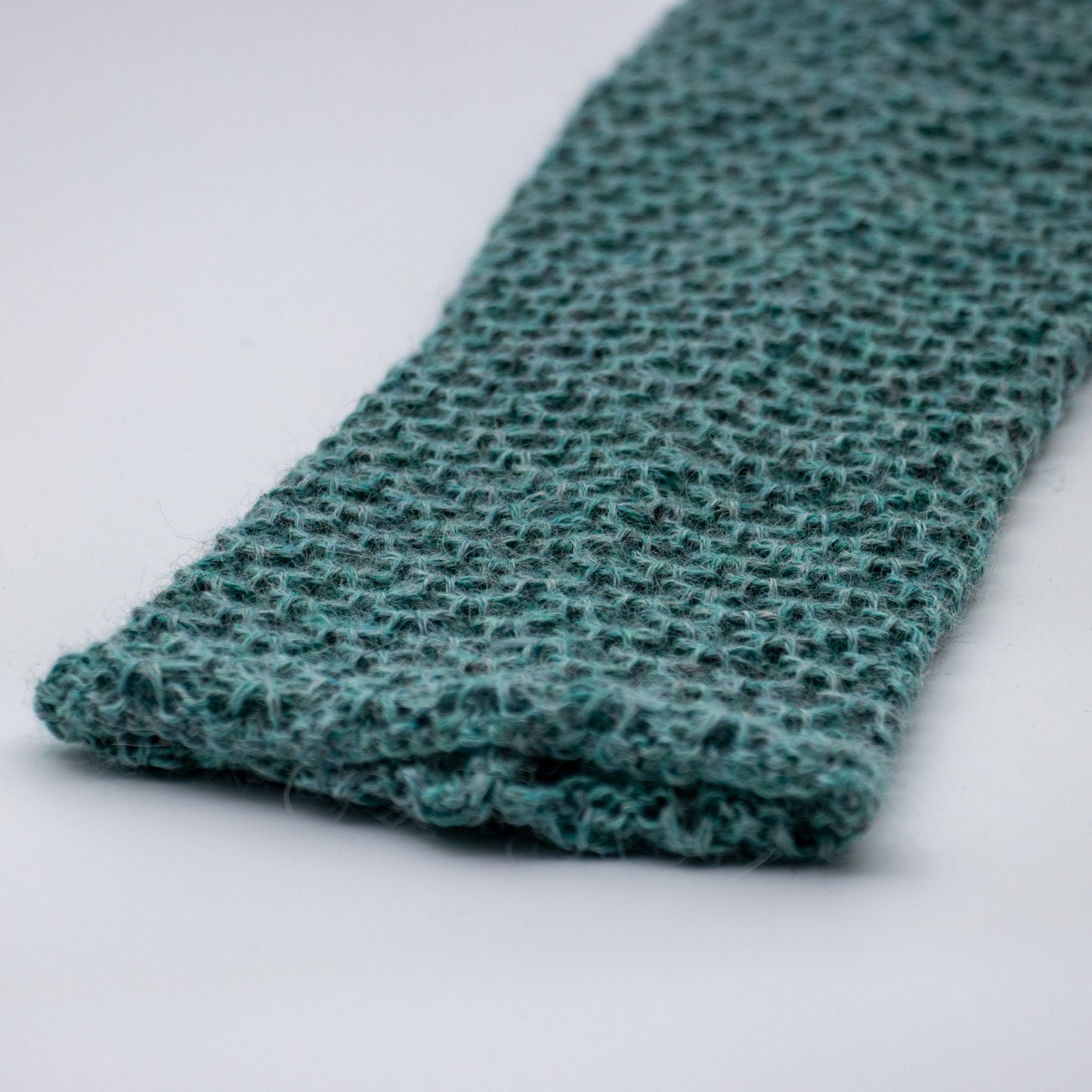 Leggvarmere alpakka melert mørk turkis - PREG Interiør