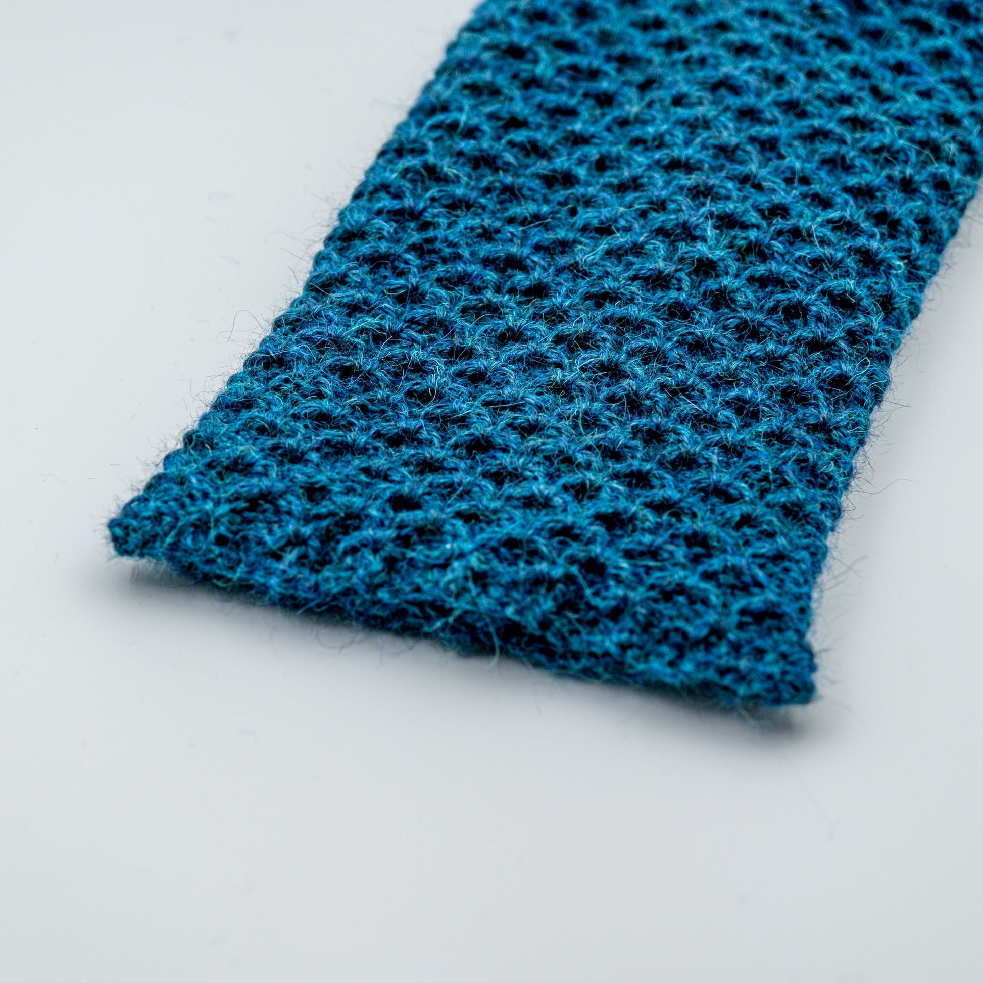 Leggvarmere alpakka melert mørk petrol - PREG Interiør